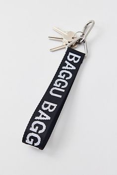 a keychain with the word reggego on it is hanging from a pair of scissors