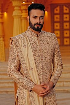 Gold sherwani with all-over floral motif jaal pattern embroidery. Comes with kurta, dupatta and churidar.
Components:4
Embroidered
Neckline:Mandarin Collar
Sleeve Length: Full
Fabric:Raw Silk
Color:Gold

Side slits
Closure: Sherwani: Concealed placket
 - Aza Fashions Eid Raw Silk Sherwani With Intricate Embroidery, Eid Sherwani With Intricate Embroidery In Raw Silk, Traditional Chikankari Embroidered Sherwani In Raw Silk, Embroidered Jamawar Sherwani With Traditional Drape, Traditional Sherwani With Intricate Embroidery For Eid, Intricate Embroidered Sherwani For Eid, Eid Sherwani With Intricate Embroidery In Jamawar, Eid Sherwani With Intricate Embroidery And Traditional Drape, Eid Raw Silk Bandhgala With Dupatta