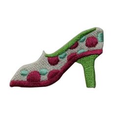 a pair of women's shoes with pink and green polka dots on the heel