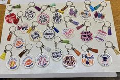 a bunch of key chains that have different designs on them, all in different colors