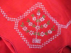 a red shirt with white and green designs on it