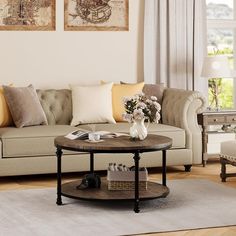 a living room with two couches and a coffee table in front of the window