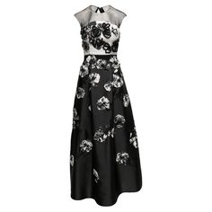 Black and white sleeveless floral applique evening dress by Sachin & Babi Noir. Crew neck. Sheer mesh panel at shoulders. Zip closure at back. 28" bust, 25" waist, 58" length, 15" shoulder width.