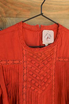 Glasgow Cotton & Rye Short Sleeve Crochet Peasant Top in Rust The Glasgow short sleeve Cotton & Rye crochet peasant top in a great tone of rust is quite elegant! This amazing peasant top features ruffled short sleeves, crew neckline, keyhole button back closure, pleated front, embroidery detail on front, and embroidery details on neckline and sleeves. This beautiful top is perfect for pairing with shorts or jeans; as it will add flair to any outfit! Product Details Ruffled Short Sleeves Crew Nec Night Tops, Sleeve Crochet, Ruffle Shorts, Top Graphic Tees, Peasant Top, Peasant Tops, Rye, Embroidery Details, Graphic Tee Shirts