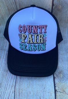 --- **Title black Trucker Hat - "County Fair Season" - Perfect for fair fun! **Description Celebrate the spirit of the county fair with our black trucker hat, featuring the lively slogan "County Fair Season"on the front. This hat combines comfort and style with its breathable mesh back, adjustable snapback closure, and bold hot pink color. Whether you're browsing the stalls, enjoying rides, or indulging in fair treats, this hat is your go-to accessory for all the  fair fun!   - Mesh Back: 100% P Trucker Baseball Cap For Festival, Adjustable Fun Trucker Hat For Country Events, Fun Adjustable Trucker Hat For Country Events, Retro Black Hat For Spring, Summer Trucker Hat For Country Events, Country Style Festival Trucker Hat, Retro Trucker Hat For Country Events, Festival Trucker Baseball Cap With Curved Brim, Festival Trucker Cap With Curved Brim