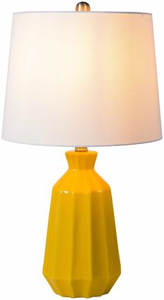 a yellow table lamp with a white shade