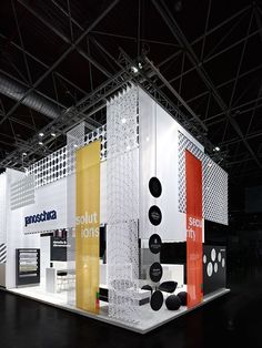 an exhibit booth with several different types of items on the walls and floor, all in various colors