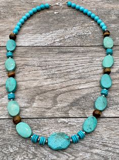 Turquoise Magnesite, Agate & Sterling Silver Statement Necklace Genuine Turquoise Magnesite Genuine Agate Sterling Silver Lobster Claw Clasp Crafted and Finished by Hand Approximate Measurements: Length 30" Adjustable with 2" Extender Live your best life when you are wearing this powerful gemstone statement necklace. This necklace will pair perfectly layered over a turtleneck or tunic or pair with a V-neck t-shirt and a pair of jeans. Bohemian Turquoise Agate Jewelry, Turquoise Jewelry With Round Natural Stone Beads, Turquoise Gemstone Beads For Jewelry Making, Turquoise Gemstone Necklaces With Round Beads, Artisan Blue Amazonite Necklaces, Bohemian Turquoise Amazonite Jewelry, Turquoise Blue Necklace With Natural Amazonite Stones, Turquoise Beaded Necklace With Round Gemstone Beads, Turquoise Gemstone Necklace With Round Beads