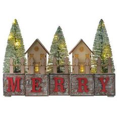 a wooden block with the word merry spelled out in front of christmas trees and houses