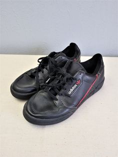 "Black with red and white elements leather lace up women Adidas sneakers. Sport flat shoes. Textile lining inside. Size EU 37. Made in Indonesia. labeled size: EU 37 1/2 / UK 4 1/2 / US 5 / JP 235. Estimated size is EU 37, US 6. condition: normal, used condition. Open a little bit right foot shoe frontal seam, but not practical meaning. measurements: sole heel height 2,5 cm / 0.98\" in outsole length 26 cm / 10.1\" in #s1103" Black Flat Heel Sporty Skate Shoes, Black Sporty Skate Shoes With Flat Heel, Sporty Black Skate Shoes With Flat Heel, Casual Adidas Logo Custom Lace-up Sneakers, Custom Leather Lace-up Sneakers With Elastic Laces, Custom Leather Low-top Sneakers With Elastic Laces, Leather Lace-up Skate Shoes, Leather Skate Shoes With Elastic Laces, Leather Skate Shoes With Elastic Laces For Streetwear