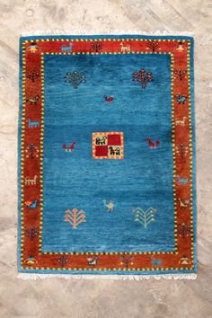 a blue and red rug with animals on it