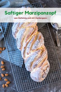 a loaf of bread sitting on top of a cooling rack next to some almonds