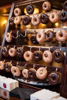 doughnuts are hanging on the rack and ready to be eaten