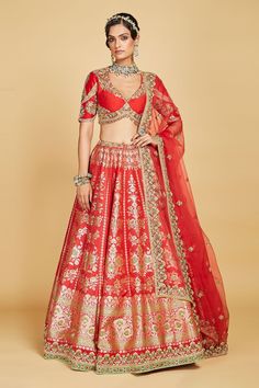 Crimson red lehenga crafted in banarasi silk base accentuated with contrast floral pattern in gold. Paired with V hem cutdana floral embellished and bow tie up blouse. Comes with cutdana and pearl embellished dupatta.
Component: 3
Pattern: Hand Embroidered 
Type Of Work: Zardosi, Pearl, Sequins
Neckline: Plunging V Neck
Sleeve Type: Half Sleeves
Fabric: Blouse and Lehenga: Pure Banarasi Silk, Dupatta: Organza Silk
Color: Red
Other Details: 
Padded blouse
Attached Can Can
Green cutdana embellishe Festive Lehenga For Puja, Fitted Sharara For Puja, Red Semi-stitched Traditional Wear With Tilla Details, Semi-stitched Red Traditional Wear With Tilla, Red Semi-stitched Traditional Wear With Tilla, Red Bollywood Style Set With Pallu, Festive Red Tilla Sets, Red Dupatta With Tilla Detail, Traditional Red Anarkali Set With Tilla