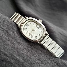 Woman Wrist Watch, Silver Colour Watch, Roman Numeral Dial, Modern Design Watch, Easy Adjustable Band, White Dail, Gift for Her, Mother's Day Gift, Valentine's Day Gift, Present for Her, Daily Usage Diamensions: - Case Thickness: 8 mm - Total Lenght: 22,5 cm - Case Diameter: 25,5 mm x 21,5 mm - Weight: 45 gr Silver Analog Display Watch, Vintage Stainless Steel Watch With Adjustable Fit, Vintage Adjustable Stainless Steel Watch, Vintage Stainless Steel Adjustable Watch, Presents For Her, Roman Numeral, Silver Colour, Women Wrist Watch, Roman Numerals