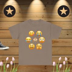 Looking for a tee that combines comfort, style, and humor? Our Unisex Heavy Cotton Tee featuring a funny emojis graphic design is the perfect pick! Whether you're an emoji enthusiast or just love a good laugh, this t-shirt is sure to bring smiles wherever you go. Why You'll Love It: High-Quality Cotton: Made from durable, heavy cotton that feels soft against your skin, this tee is designed for everyday wear. Perfect for lounging at home, hanging out with friends, or adding a playful touch to you Casual T-shirt With Character Print For Gift, Casual T-shirt With Character Print As Gift, Emoji Faces, Trendy Graphic Tees, Funny Emoji, Fantastic Gifts, Heavy Cotton, Gift For Lover, Graphic Tees