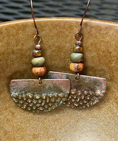 Rustic antique Hammered copper dangle earrings with jasper stones.  Looking for something lightweight, unique and natural? This simple yet elegant pair of hammered copper earrings will definitely make you smile!  These earrings have a very unique hammered texture. The color of the copper changes with the light. They have an antique patina finish for a rustic look. The stones are varieties of jasper.  These earrings are 1 inch in diameter. They are very light weight, less than 3 grams. The French Bohemian Brass Earrings In Rust Color, Bohemian Rust Brass Earrings, Handmade Vintage Rust Earrings, Handmade Rust Vintage Earrings, Handmade Vintage Rust-colored Earrings, Earthy Bronze Earrings With Ear Wire, Bohemian Nickel-free Rust Earrings, Earthy Bronze Dangle Jewelry, Bohemian Rust-colored Nickel-free Earrings