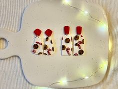 three pieces of food are arranged on a platter with candy canes and candies