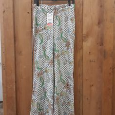 Light Weight Paisley Flower Bellbottom Pants With Elastic Waist At The Back Front Zipper And Pockets Spring Printed Green Wide Leg Pants, Floral Print Cotton Pants, Spring Green Printed Wide Leg Pants, Spring Green Wide Leg Pants With Floral Print, Green Floral Print Wide-leg Pants, Spring Floral Print Green Wide Leg Pants, Spring Green Floral Print Wide Leg Pants, Green High-waisted Pants With Floral Print, Green Printed Trousers