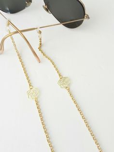 Sunglasses gold chain,  Eyeglass necklace, Flowers sunglasses chain, Dainty reading glasses gold chain, Trendy Chain, Eyewear Holder Chain Beautiful fashion trend sunglasses gold plated aluminum chain decorated with gold plated flowers Lightweight gold chain with rubber ends Total length is 70cm / 27.7 inches. Beautifully packaged and ready for gift giving.  JEWELRY CARE: Please take care of your jewelry do not wear in the shower, swimming pool, or to bed.  Keep away from harsh chemicals and cle Glass Necklaces With Gold Chain For Gift, Elegant Metal Glasses Chain With Adjustable Chain, Elegant Metal Glasses Chain With Adjustable Length, Elegant Metal Glasses Chains With Chain Strap, Elegant Metal Glasses Chains, Gold Glass Necklace With Adjustable Chain, Adjustable Gold Glasses Chain With Strap, Elegant Silver Glasses Chain With Chain Strap, Elegant Glass Necklace With Chain Strap