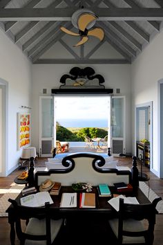 a living room filled with furniture and a ceiling fan