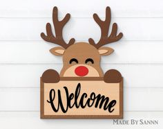 a wooden sign that says welcome with a reindeer head