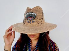 I love Mexico celebrates the native crafts of Mexico and the artists that produce them, enabling them and their communities to get recognized for their talented work and achieve economic stability for their families. This listing is for one piece of this beautiful handmade straw hats. They are prefect to add to your closet for your favorite dress, providing shade from the warm summer sun. The eye decoration is hand embroidered. Consist of decorative gems. You will get the exact same piece shown Handmade Flat Brim Toquilla Straw Hat, Embroidered Straw Hat For Beach With Short Brim, Artisan Straw Hat For Summer, Artisan Handmade Sun Hat For Spring, Handmade Artisan Sun Hat For Spring, Artisan Beach Hats One Size, Handmade Toquilla Straw Fedora Hat, Handmade Toquilla Straw Fedora, Handmade Artisan Panama Hat For Summer