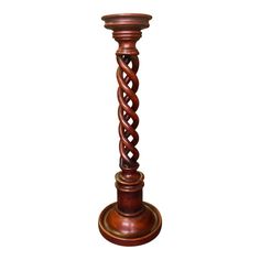 a tall wooden candle holder with an intricate design on the top and bottom, sitting in front of a white background