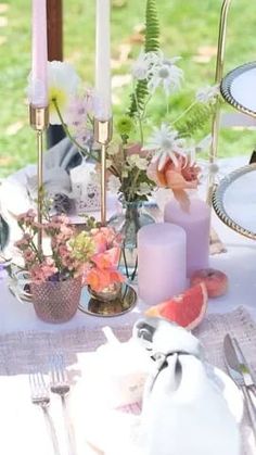 the table is set with flowers and candles