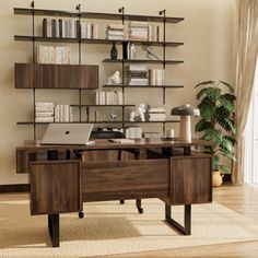 a computer desk sitting in front of a book shelf