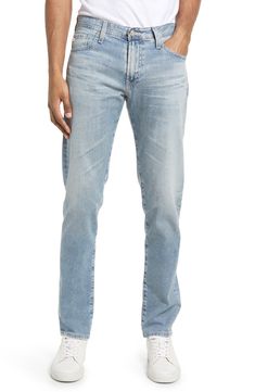 A well-worn wash puts a classic stamp on slim-cut jeans shaped from stretchy cotton denim. 33" inseam; 13" leg opening; 10 1/4" front rise; 15" back rise (size 32) Zip fly with button closure Five-pocket style 98% cotton, 2% polyurethane Machine wash, tumble dry Imported Men's Clothing Ag Jeans, Cut Jeans, Stretch Jeans, Men's Clothing, Levi Jeans, Slim Fit, Nordstrom, Stamp, Mens Outfits