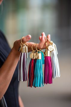 a woman holding several tassels in her hands