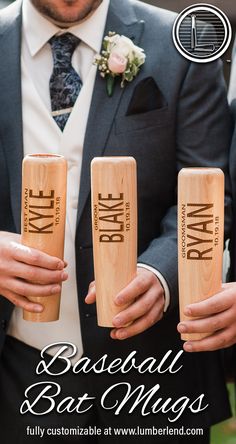 a man in a suit and tie holding three wooden salt shakers with the words baseball bat mugs printed on them