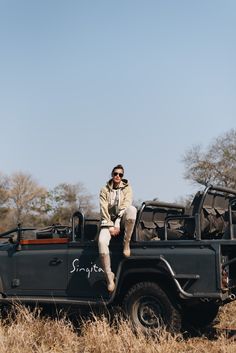 a man sitting on the back of a black jeep