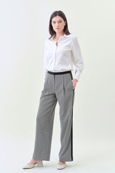 Combining classic tailoring with modern details, our Pleated Wide Pant offers an effortlessly sophisticated silhouette. With a comfortable mid-rise and a pleated wide fit, pair it with our Classic Blazer for a luxe statement. Details Hidden hook-and-bar closure Comfortable mid-rise Wide trouser fit, regular length Side pockets Contrast stripe detail Houndstooth suiting fabric upcycled from premium deadstock Machine washable Chic Wide Leg Pants For Workwear With Straight Hem, Chic Wide Leg Pants For Workwear, Chic Wide Leg Pants For Office With Straight Hem, Chic Wide Leg Pants For Office, Classic Houndstooth Pants For Business Casual, Classic Houndstooth Formal Pants, Classic Formal Houndstooth Pants, Modern Wide Leg Work Pants With Straight Hem, Modern Wide Leg Pants With Straight Hem For Office