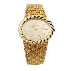 Ladies Corum 26mm x 30mm Oval Vintage 18K Yellow Gold Watch with Gold Dial and Weave Bezel. Pre-Owned SN# 163**** Brand: Corum. Dial Color: Gold. Type: Wristwatch. Gender: Women's. Condition: Excellent. Bezel: 18K Yellow Gold. Total Weight: 62 Grams. Case Size: 26mm x 30mm. Movement: Quartz (Battery). Band Material: 18K Yellow Gold. Bezel Material: 18K Yellow Gold. Bracelet Size: Fits 6.5" to 6.75" Wrist. Warranty: One (1) Year Limited Service Warranty. Yellow Gold Oval Watch For Gift, Oval Yellow Gold Watch As Gift, Oval Yellow Gold Watches For Gifts, Gold Oval Watch With Diamond Hour Markers, Gold Oval Watches With Diamond Hour Markers, Luxury Gold Oval Watch, Luxury Oval Gold Watches, Gold Oval Watches For Anniversary, Corum Watches