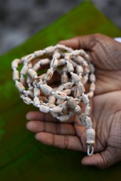 "Introducing our exquisite Tulsi Japa Mala, a sacred accessory designed for meditation and prayer, crafted with utmost care and devotion. This spiritual tool is handcrafted with precision, featuring 108 cylindrical beads made from the sacred Tulsi wood. Each bead is a testament to the rich tradition and cultural significance that Tulsi holds in spiritual practices. Mala Length 40 inches. The Tulsi Japa Mala boasts a unique design, with its cylindrical beads gradually decreasing in size from a substantial bead size of 2 cm to a smaller, delicate size of 1.5 cm. This meticulously crafted arrangement not only enhances the aesthetic appeal of the Mala but also ensures a comfortable grip and smooth touch, allowing your fingers to glide over the beads effortlessly during your meditation and pray Handmade Spiritual Mala, Spiritual Wooden Beads Mala For Meditation, Spiritual Wooden Beads Jewelry For Meditation, Handmade Spiritual Mala For Rituals, Adjustable Artisan Mala For Rituals, Traditional Handmade Mala For Meditation, Holistic Healing Mala With Wooden Beads, Holistic Wooden Beads Mala For Rituals, Artisan 108 Beads For Meditation