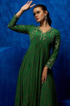 Emerald natural crepe dress with all over contrast bloom print, high-low hem, contrast metallic zari, bead and sequin hand embroidered yoke. - Aza Fashions Green V-neck Dress For Festive Occasions, Green V-neck Dress For Festive Season, Festive Green V-neck Dress, Festive Anarkali Maxi Dress With V-neck, Festive Green Maxi Length Dress, Festive Anarkali V-neck Dress, Festive Sequined Midi Dress, Festive Anarkali Dress With V-neck, Festive Green Maxi Dress