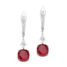 Perfect your attire with these stylish red ruby and diamond earrings. Crafted in 18K white and rose gold, each eye-catching design features a striking cushion-cut red ruby in a rose gold cat claw four-prong setting, topped by a round diamond hanging from a sparkling post. Radiant with 4ct. t.w. these spectacular drops suspend from English lock backs.
1.25 carat cushion cut natural red ruby
1.25 cushion-cut natural red ruby -
0.50-carat shield cut diamonds
0.35 carat pave diamond s Ruby Drop Earrings, Ruby And Diamond Earrings, Blood Ruby, Emerald Earrings Drop, White Diamond Earrings, Tanzanite Earrings, Diamond Dangle Earrings, Ruby Earrings, Diamond Drop Earrings