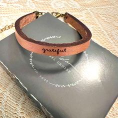 Bracelet Is Brand New. Never Worn. This Bracelet Reads "Grateful" In Laurel's Original Lower Case Script Writing. Metallic Rose Gold Color. Leather Is Approximately 2mm Thick Standard Size - 7.25" Bracelet Is 1/4-Inch Wide - The Writing Is Very Small & Delicate Metal Details Made From Brass (Includes Extender Chain) All Handmade In The Us Metallic Rose Gold, Script Writing, Lower Case, Rose Gold Color, Lowercase A, Womens Jewelry Bracelets, Leather Bracelet, Gold Color, 4 Inch