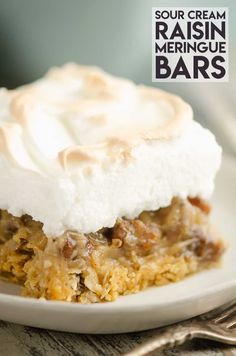 a close up of a plate of food with marshmallows on it and the words sour cream raisin meringue bars