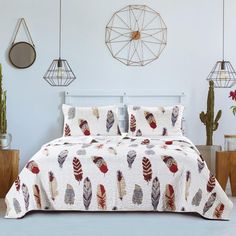 a bed room with a neatly made bedspread and decorative items on the wall