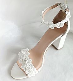 Pearl Lace Block Heel Wedding Shoes for Bride  Step into a world of romance and sophistication with our exquisite Wedding Shoes featuring delicate white flowers with pearls, carefully handcrafted to elevate your bridal ensemble with timeless elegance. The luxurious leather lining is cushioned in all the right places to ensure ultimate comfort. Handmade with the utmost care and attention to detail. Indulge in luxurious comfort as you walk down the aisle in style. *White or Ivory cow leather *Bloc Elegant Lace Wedding Shoes With Ankle Strap, Elegant Low Heel Wedding Shoes With Lace Trim, Formal Wedding Shoes With Lace Trim And Closed Toe, White Lace Wedding Shoes With Ankle Strap, Evening Lace Wedding Shoes With Ankle Strap, Elegant Summer Wedding Shoes With Lace, Elegant Summer Wedding Shoes In Lace, White Lace Ankle Strap Wedding Shoes, Elegant Lace Wedding Shoes For Summer