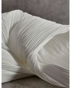 white pleated fabric on the back of a chair