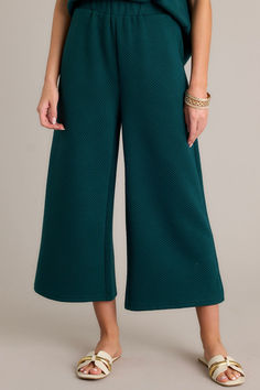 Say hello to your new go-to pants! These Tell Me Forest Green Cropped Textured Pants are not only stylish, but also comfortable and versatile. Perfect for making a statement, you'll love the unique texture and playful color (not to mention the flattering cropped length). Get ready to turn heads and make a statement! These pants feature a high waisted design, an elastic waistband, functional hip pockets, a textured crisscross design, and a wide leg. Green Fall Loungewear Bottoms, Green High-waisted Wide Leg Pants For Fall, Green Wide Leg Pants For Loungewear In Fall, Green Wide Leg Pants For Fall Loungewear, Green Wide Leg Pants For Loungewear, Green Pants With Elastic Waistband For Fall, Green Ankle-length Loungewear Pants, Green Elastic Waistband Pants For Fall, Green Wide Leg Ankle-length Pants For Loungewear