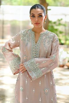 "A contemporary take on a classic kaftan silhouette, cut from tissue, in an elegant shade of blush pink. Dispersed kamdani and zardoze details with a cutworked hem elevate the look." Elegant Pink Kurta With Dabka Work, Elegant Pink Kurta With Resham Embroidery, Elegant Pink Kurta For Eid, Pink Kaftan With Dabka Work For Wedding, Pink Wedding Kaftan With Dabka Work, Elegant Pink Organza Kurta, Pink Intricate Embroidery Kaftan For Eid, Pink Resham Embroidery Kaftan For Wedding, Pink Wedding Kaftan For Eid