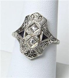 - Vintage 14k White Gold Art Deco Diamond Ring- Gorgeous details on face and shoulders- Ring size 8.25- Diamonds each measure 2mm in diameter- Ring face measures .8" tall by .72" wide and .24" deep- Wonderful vintage condition, signed / marked "BE"  "ML"- Weighs 4.2 gramsA wonderful antique ring! 14k Gold Art Deco Jewelry, Art Deco Collectible 14k White Gold Rings, Collectible Art Deco 14k White Gold Ring, Sterling Silver Rings With 17 Jewels For Formal Occasions, Art Deco Ring In Diamond White With Jewels, Art Deco 14k White Gold Ring, Art Deco 14k White Gold Wedding Jewelry, Victorian White Gold Rings With Polished Finish, Art Deco White Gold Jewelry With 17 Jewels