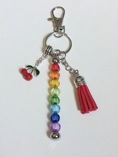 a keychain with several colors of beads and tassels hanging from it