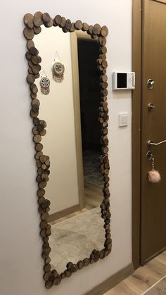 a mirror that is on the side of a wall next to a door in a room