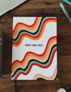 a notebook with the words good vibes only on it